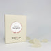 A light green rectangular product box with a circular white and sand coloured label reading 'flavours of Sauvignon' and smaller text 'The Real Wine Gum Wine Design,' photographed against a white surface beside white gummies.