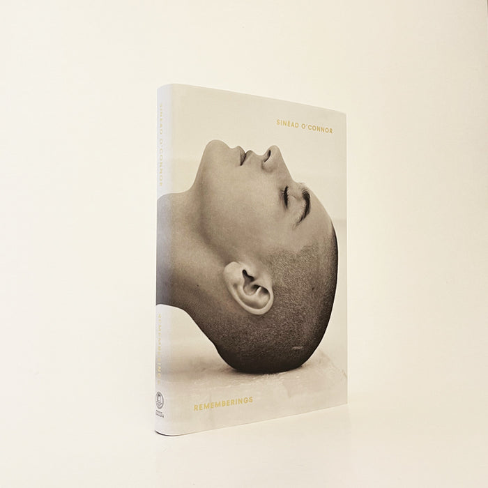 the book is standign upright on a white background. it has a photo of sinead o connor on the front