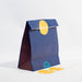 small navy reusable gift bag with plum sides. with bright yellow stick that says 'hooray!'