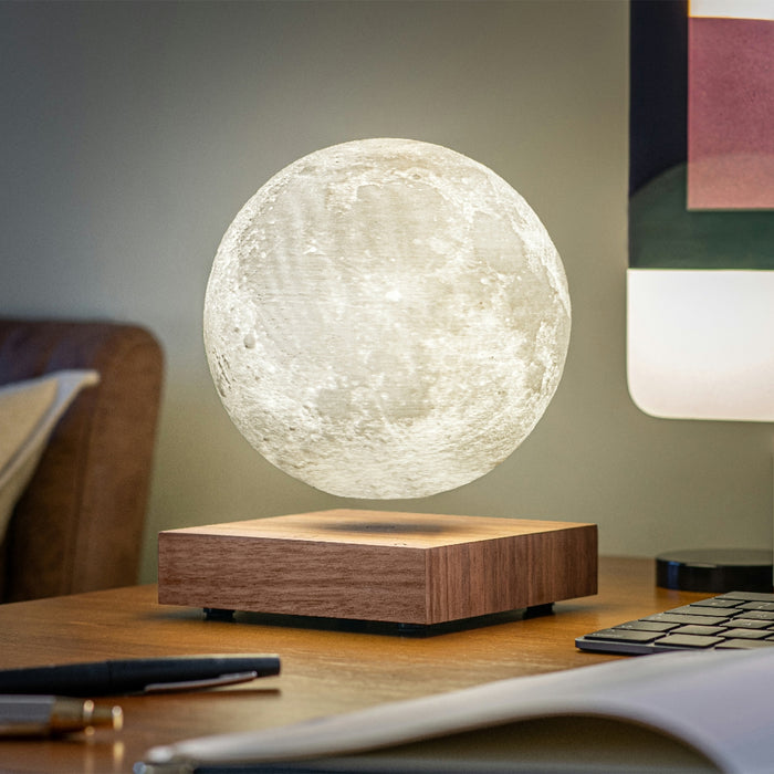office setting, the smart moon light is sitting on a wooden table