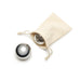 Cream pouch with two stainless steel whiskey balls on a white surface.